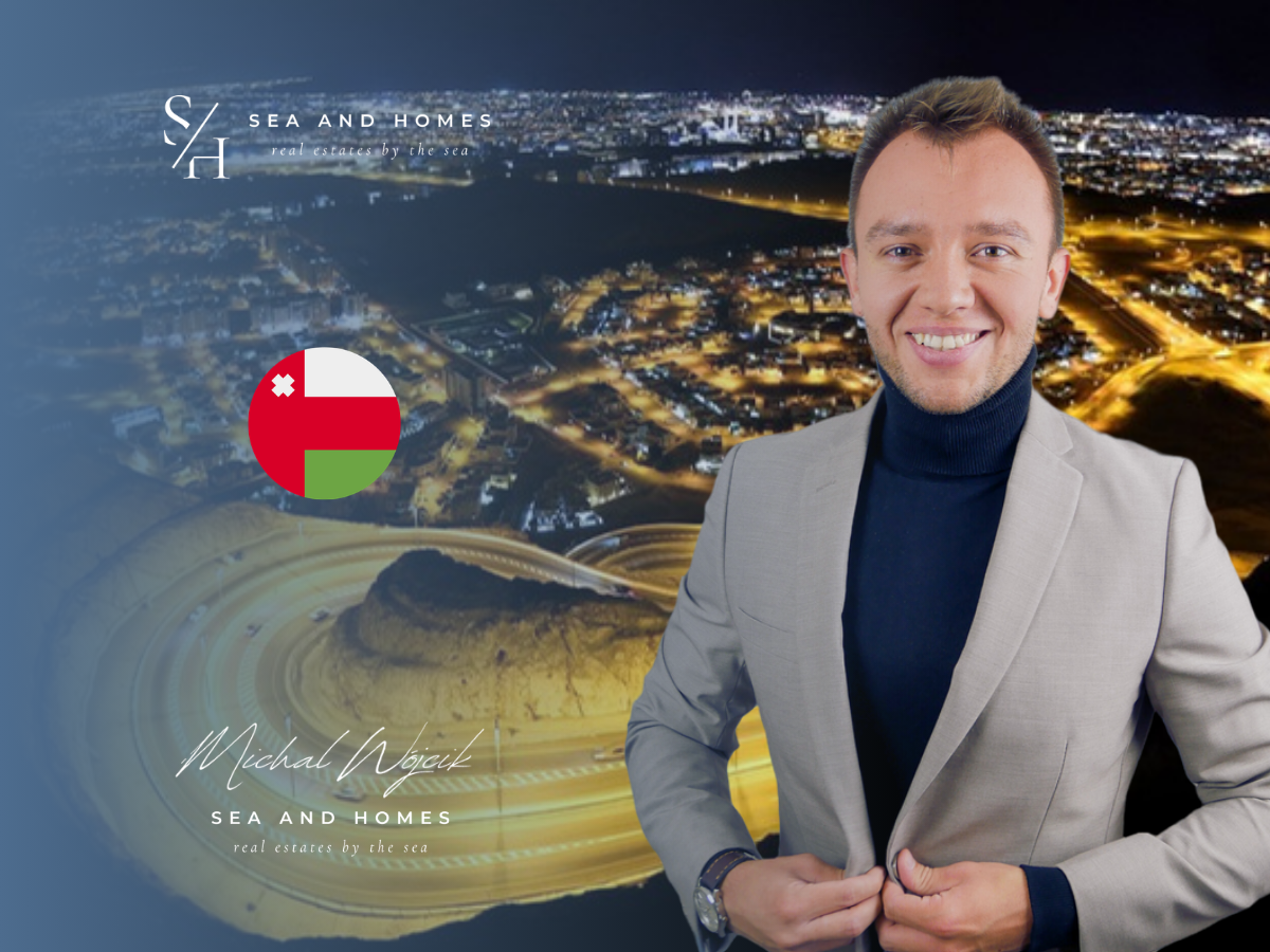 Nocny widok z lotu ptaka na Maskat w Omanie z flagą Omanu - kredyt hipoteczny na nieruchomość w Omanie 2026